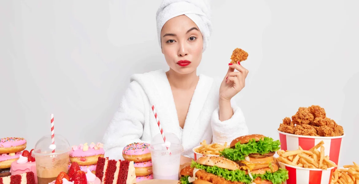 serious-asian-woman-with-red-lips-healthy-skin-holds-delicious-nuggets-eats-tasty-snacks-addicted-fast-food_11zon (1)