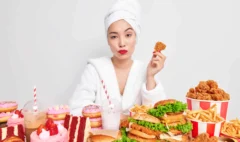 serious-asian-woman-with-red-lips-healthy-skin-holds-delicious-nuggets-eats-tasty-snacks-addicted-fast-food_11zon (1)