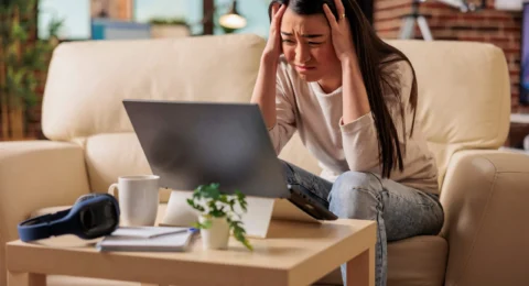 businesswoman-using-laptop-while-sitting-sofa-home (1)