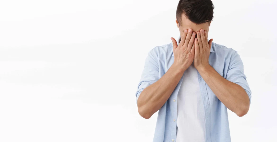 portrait-depressed-tired-young-caucasian-man-hold-hands-face-sighing-feel-regret-grief-standing-distressed-feeling-mental-breakdown-work-burnout-white-wall_11zon