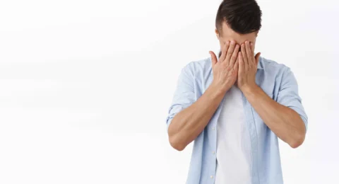 portrait-depressed-tired-young-caucasian-man-hold-hands-face-sighing-feel-regret-grief-standing-distressed-feeling-mental-breakdown-work-burnout-white-wall_11zon